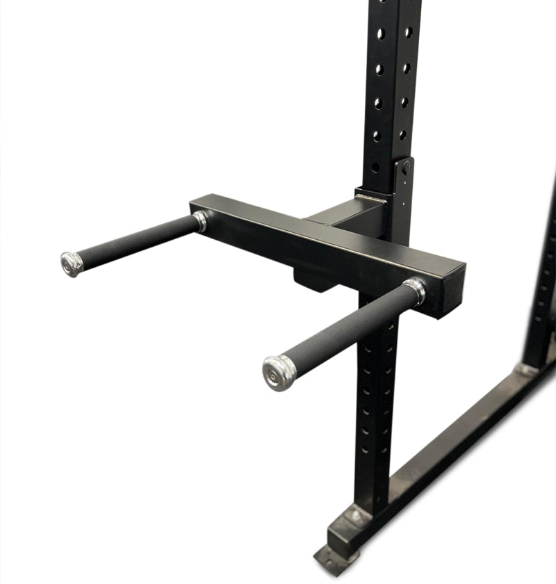 A black dip attachment for a power rack with two parallel bars and a central connecting bar, designed for upper body strength exercises.