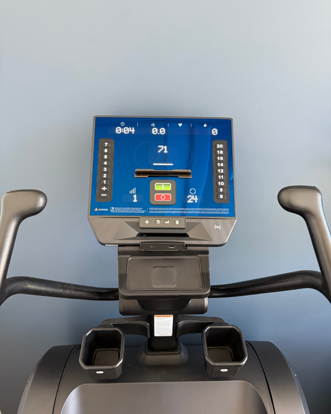 Close-up of a stair climber digital display panel with a blue screen
