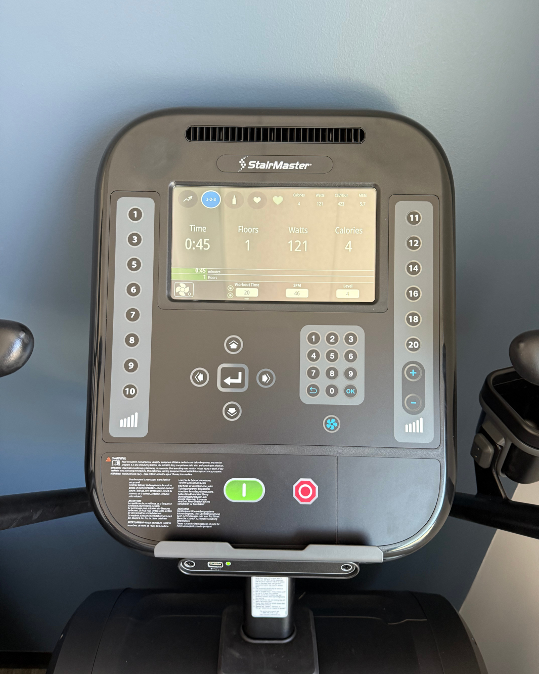 Control panel of a StairMaster exercise machine with digital display and buttons.