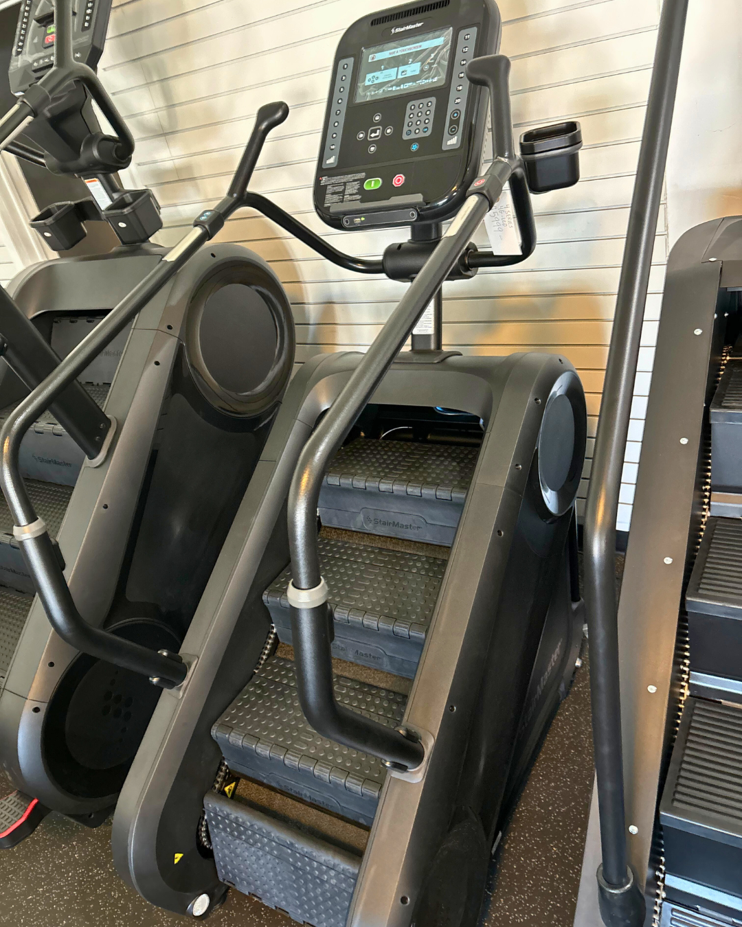 Stair climber machine in a gym setting with digital display