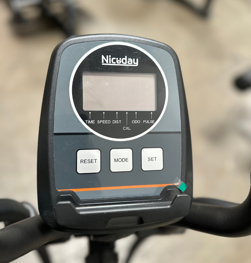 Niceday exercise bike console with digital display and control buttons on a blurred background