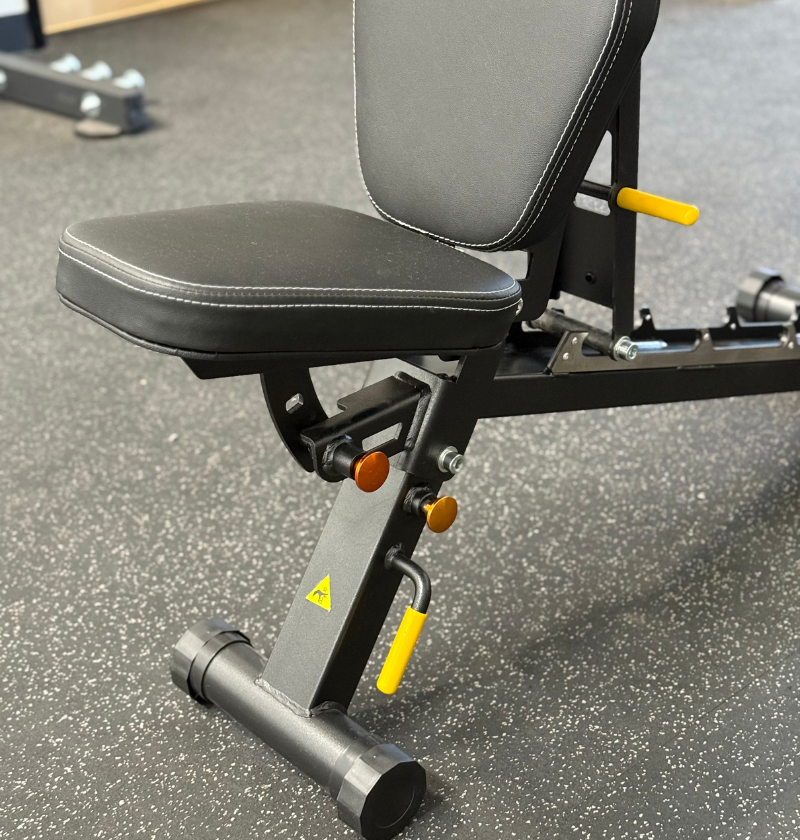 foldable gym bench on a speckled rubber floor