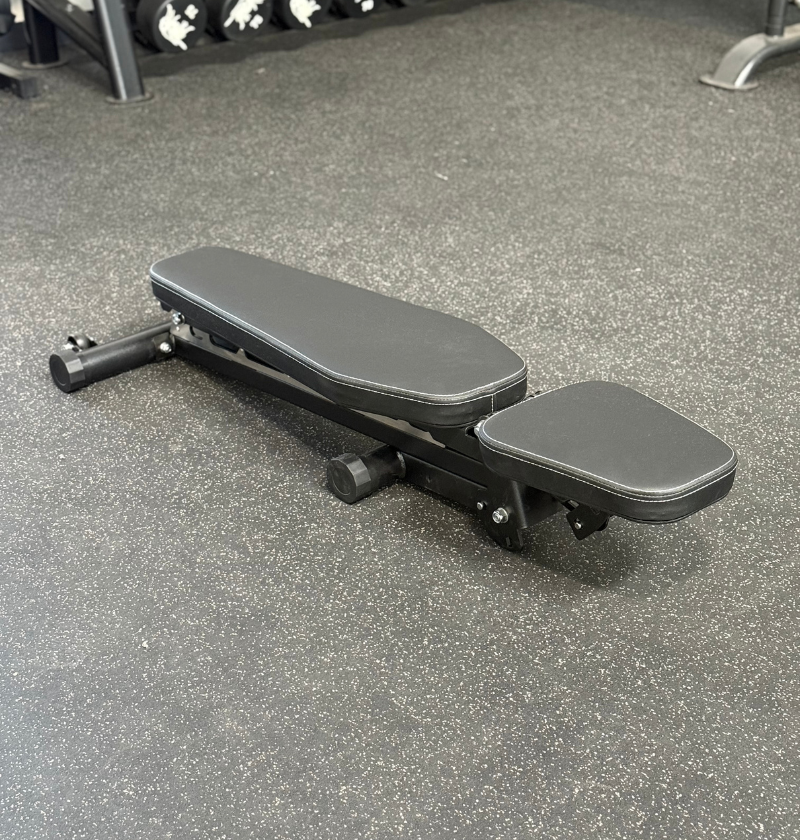Gray adjustable bench on a gym floor