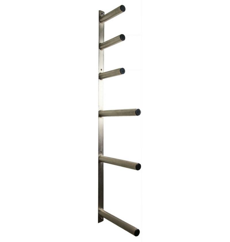 A wall mounted Olympic plate rack with multiple pegs for storing weight plates.
