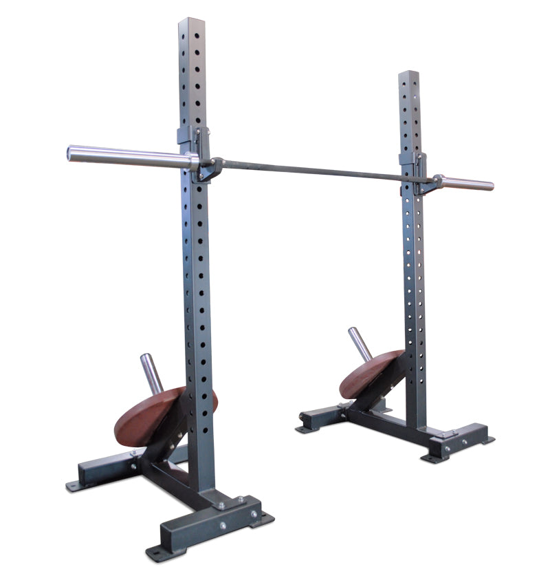 Two squat stands with a barbell positioned on each side, ready for weightlifting exercises.
