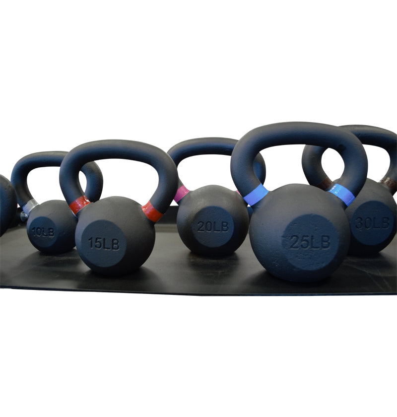 A row of black kettlebells displayed on a black surface.