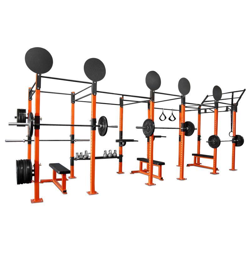 A gym setup including an ETE Freestanding Pull Up Rig, weights, and a bench, ideal for strength training and fitness routines.
