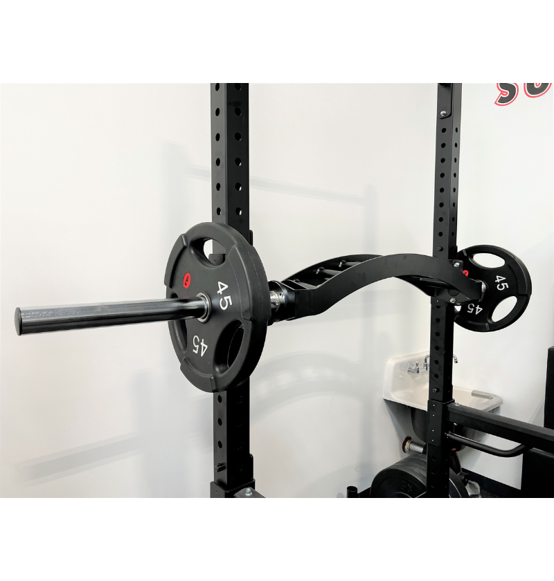 A black barbell, labeled as extreme cambered multi grip bar mounted securely on a wall, designed for weightlifting and strength training exercises.