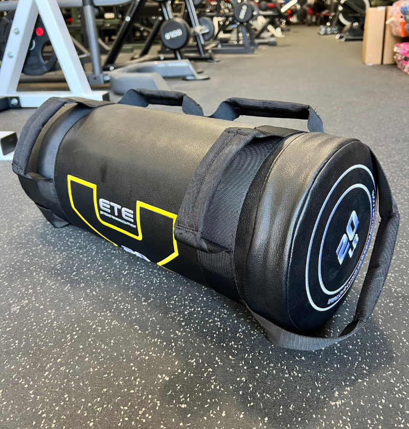 A 20lb Power Bag, large and black with yellow accents, placed on the floor.