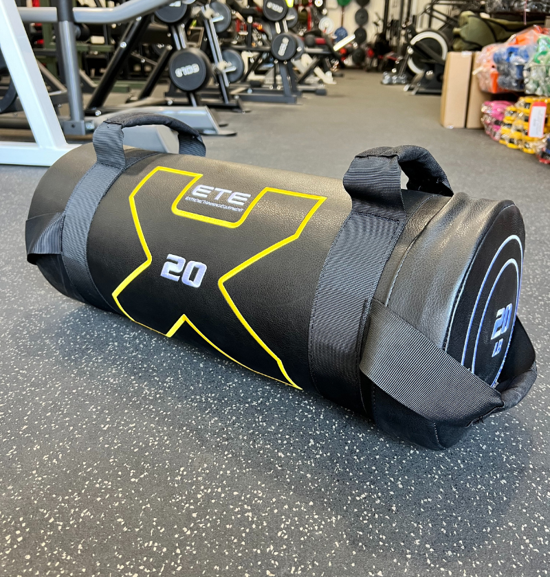 A black and yellow gym bag with "x20" printed on it, specifically for Power Bags exercises.