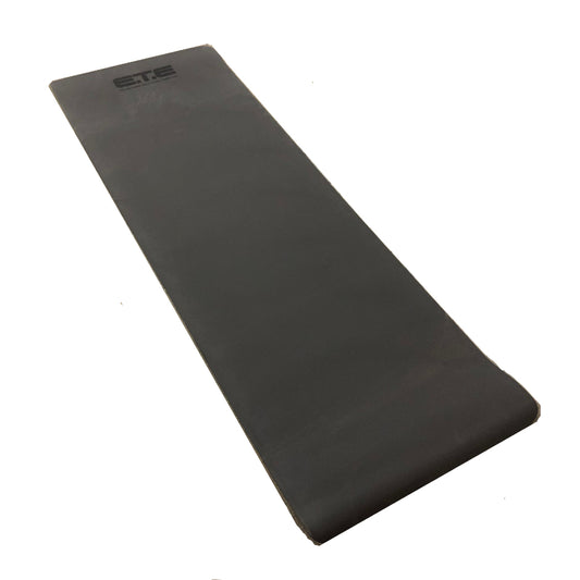 A black yoga mat displayed against a stark white background, highlighting its simplicity and functionality.