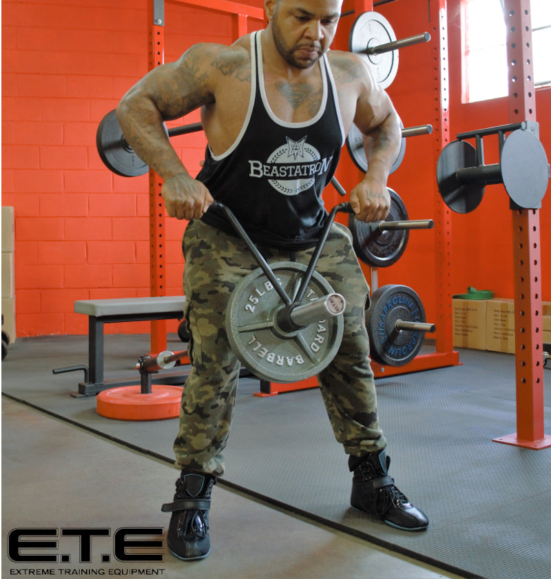 Man using T-shaped landmine handle for strength training exercises.