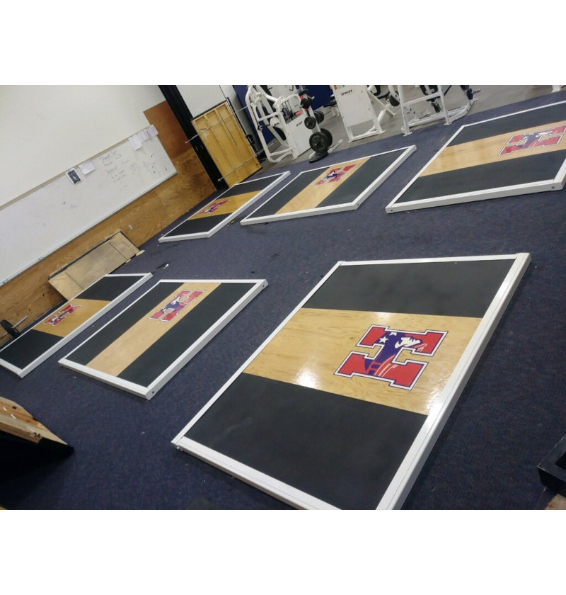A room featuring Olympic lifting platform for strength training.