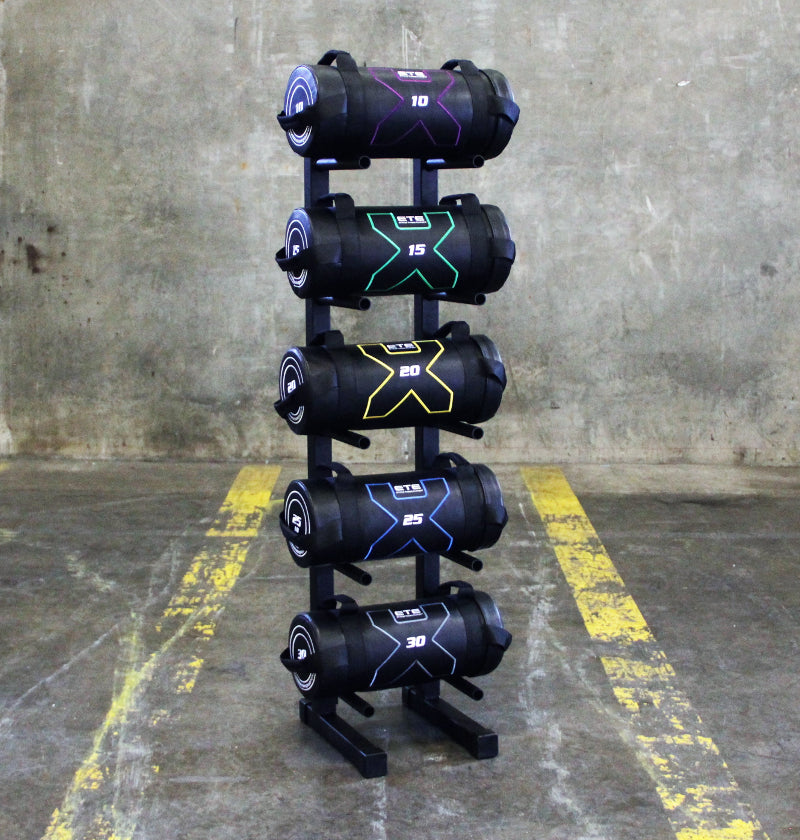 A rack displaying five Power Bags, each designed for strength training and fitness exercises.