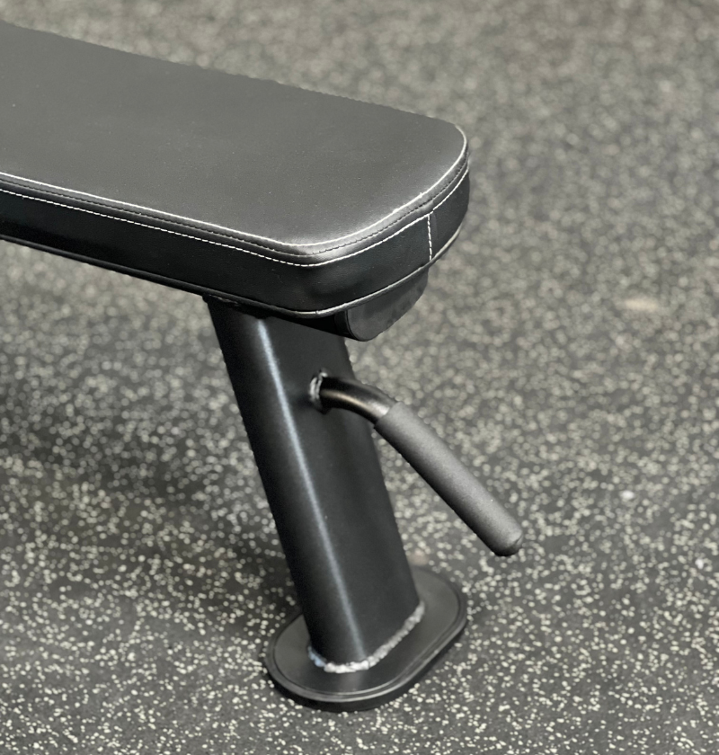A black bench featuring a sleek black seat and a matching footrest.