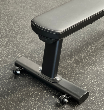 A black bench featuring a sleek black seat and a matching footrest.