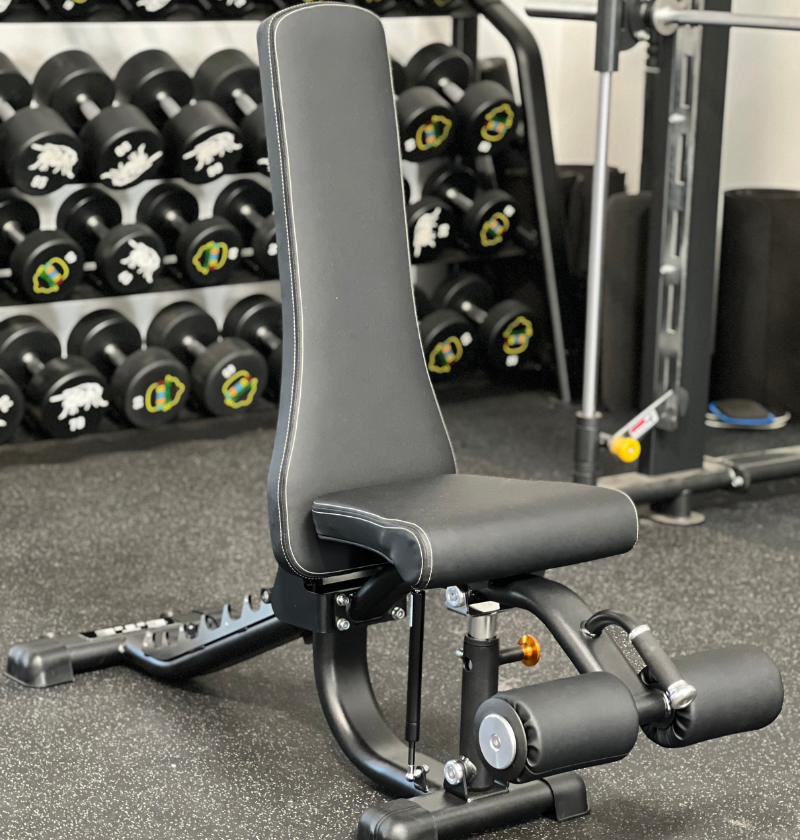 A black exercise bench equipped with a footrest, ideal for supporting various workout positions and exercises.