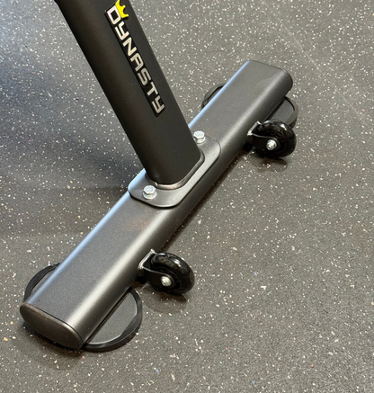 Up-close photo of the rear leg with wheels on a black tricep seat