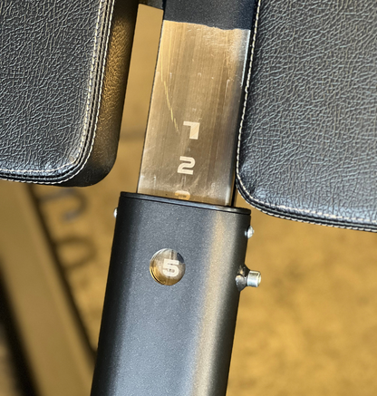 Close-up of a 45 degree hyperextension adjustment numbers on a concrete floor