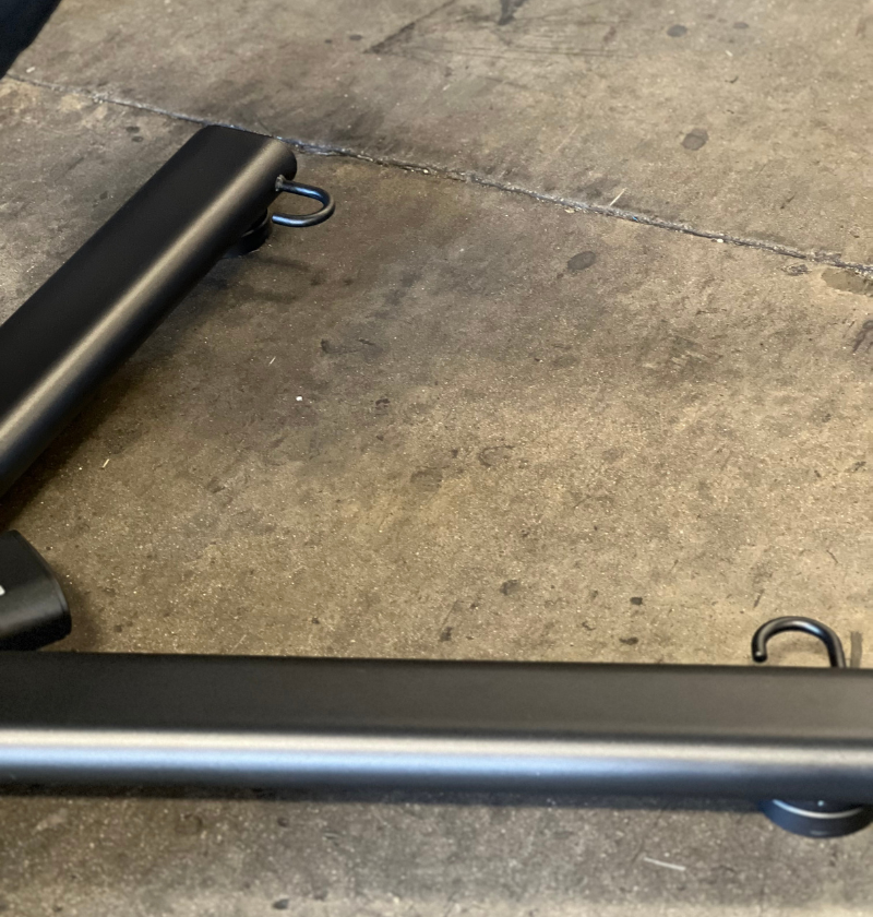 Close-up of the 45 degree hyperextension band hooks on a concrete floor
