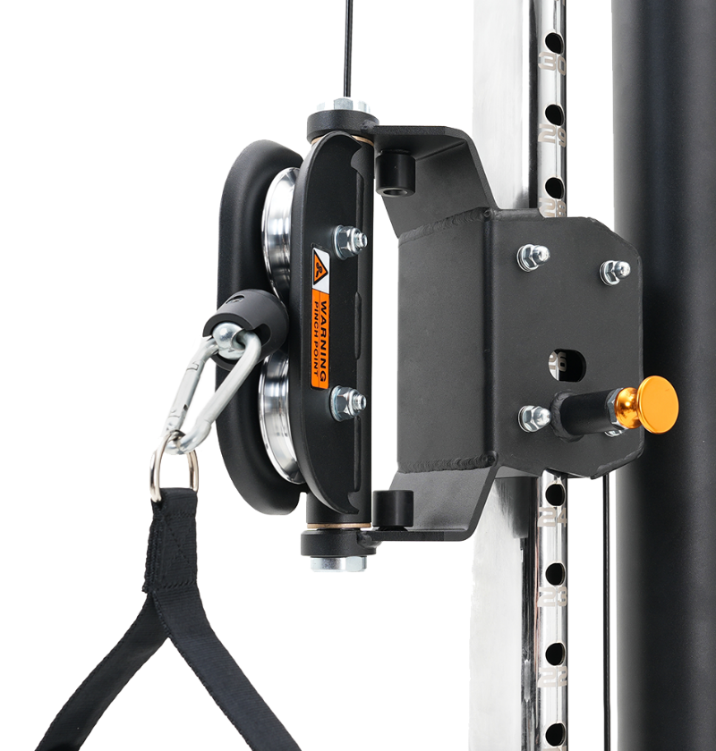 Black pulley system attached to a white metal frame with a yellow knob.