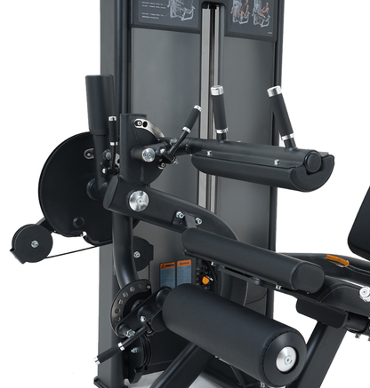 Close-up of a black leg extension leg curl machine on a white background