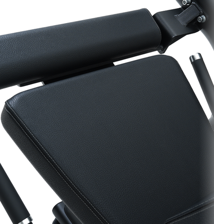 Close-up of the black seat pad on the seated leg extension leg curl machine