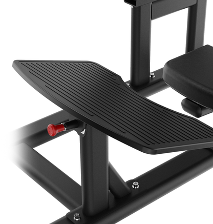 Black plate loaded hip thrust foot plate with textured surface and red clip on a white background