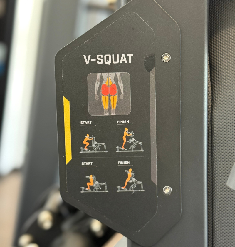 V-Squat exercise guide on a fitness machine with illustrations and text.