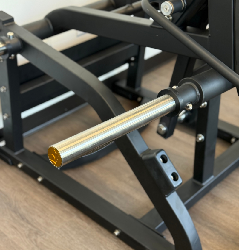 Close-up of the front squat loading peg with a wooden floor background.