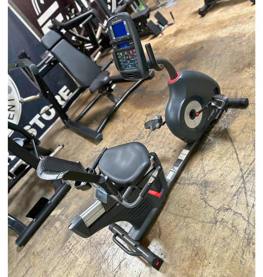 Exercise bike with digital display on a wooden floor