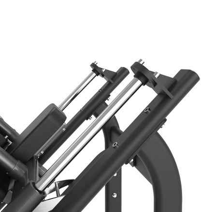 Close-up of chrome guide rods on a black hack squat machine on a white background