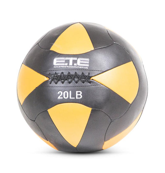 A black and yellow pro wall ball with the text '20LB' printed on it.